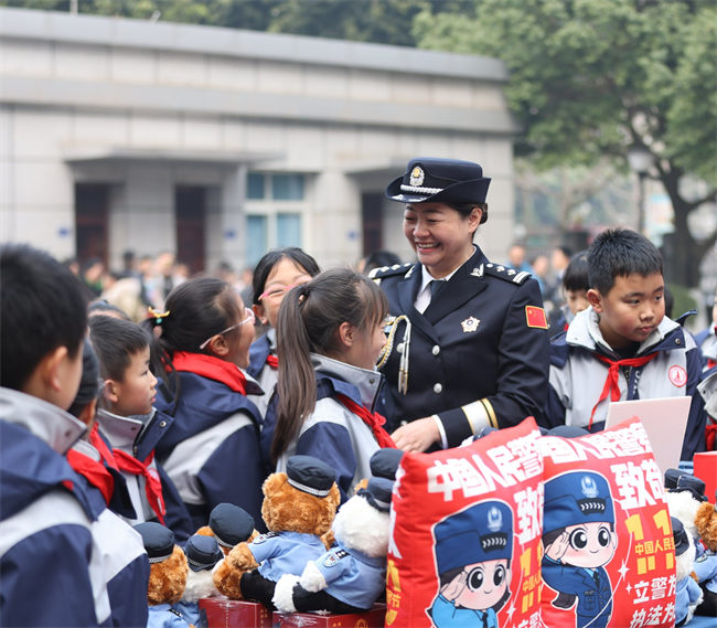 資陽市公安局工作人員給前來參加體驗活動的小學生們發(fā)放獎品。圖片來源：資陽市公安局