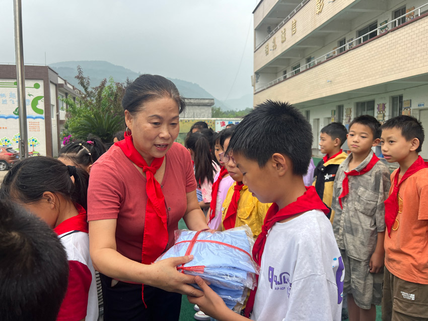 劉春香為鄉村留守兒童送去嶄新校服。中江縣委宣傳部供圖